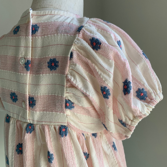 Elwen Romper on mannequin close up, back view, baby girl cotton romper , button detail — Willowby, sizes 6–18 months