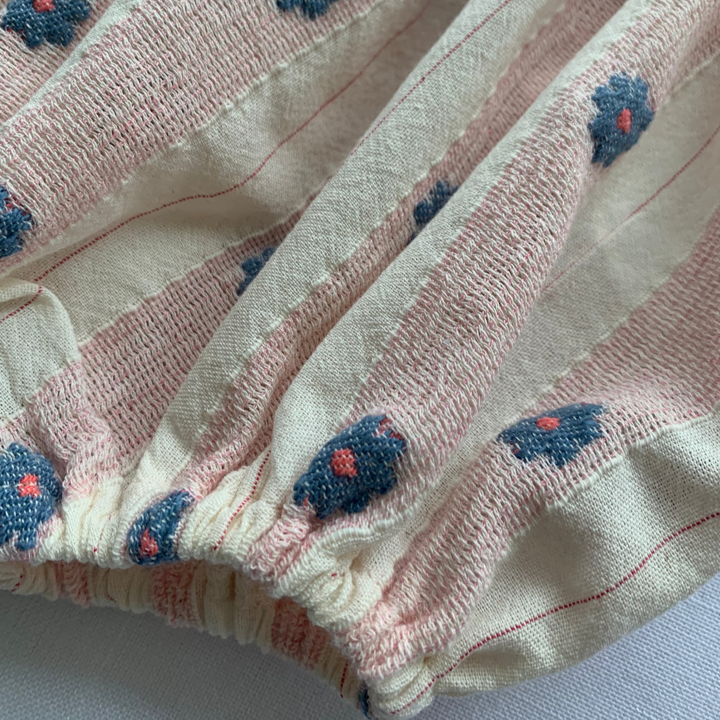 Elwen Romper flat lay, close up ,baby girl cotton bubble romper — Willowby, sizes 6–18 months