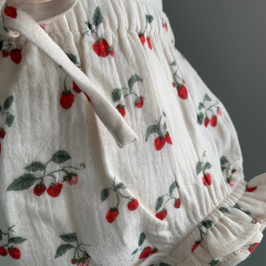 Bloomers on mannequin, close up, baby girl organic cotton bloomers, strawberry print — Willowby, sizes 6–18 months