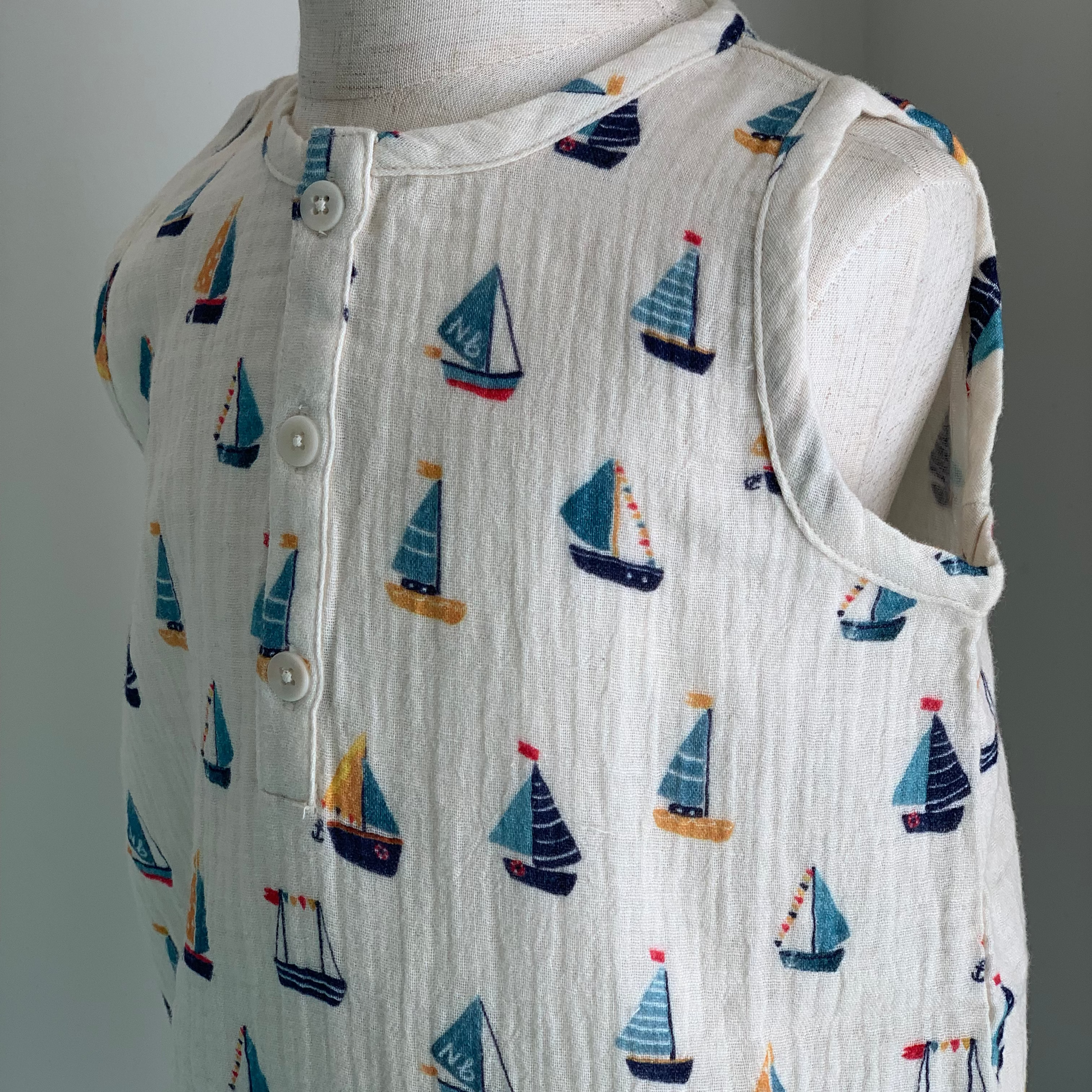 Cedar Suit on mannequin, baby organic cotton romper, button front detail,  boat print— Willowby, sizes 6–18 months