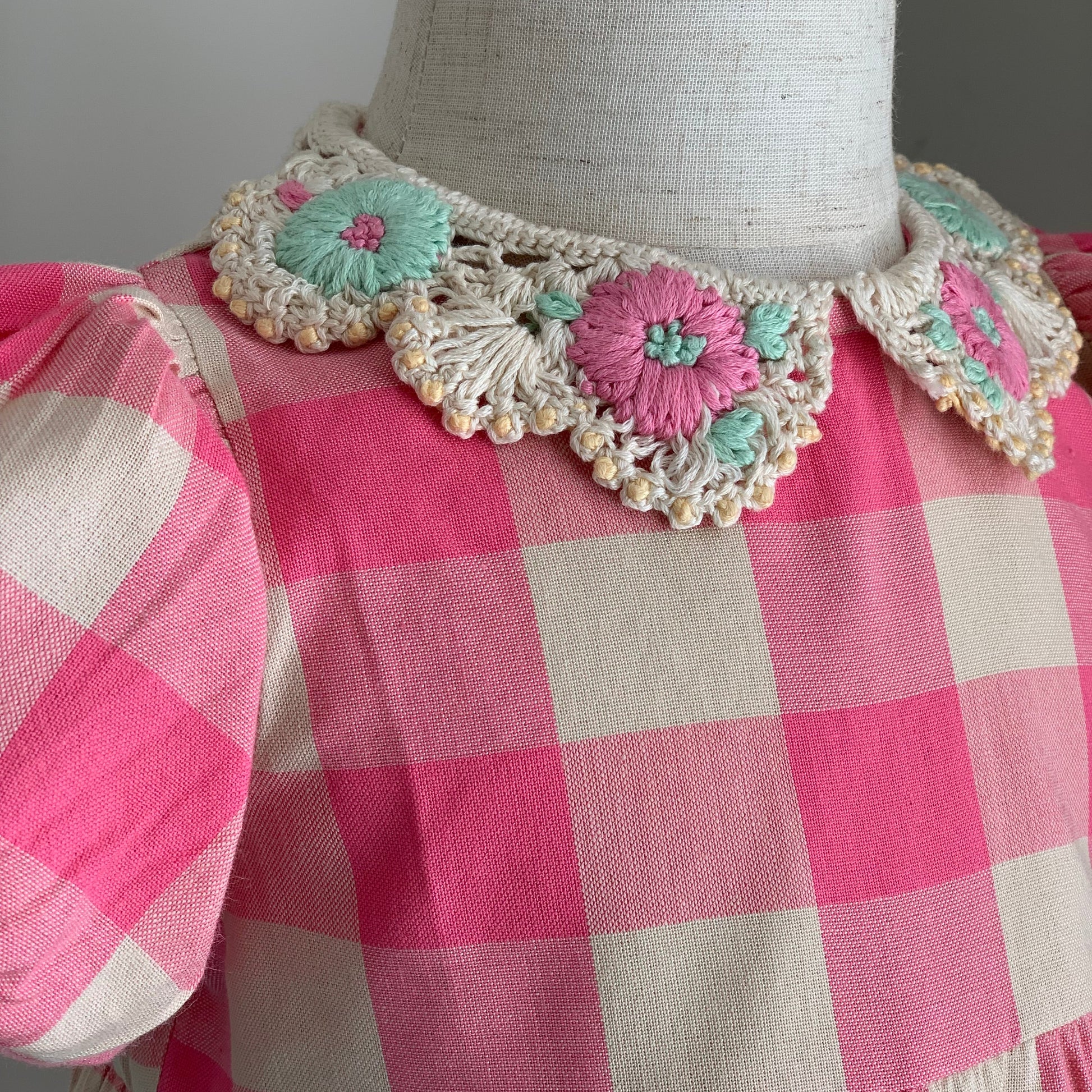 Anais Romper on mannequin close up, baby girl cotton pink check romper, crotched collar — Willowby, sizes 6–18 months