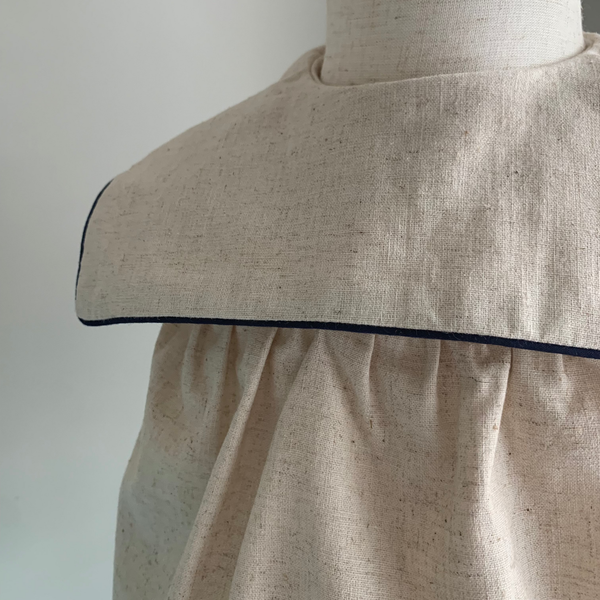 Melchior Romper on mannequin, baby boy  cotton-linen blend romper, collar detail — Willowby, sizes 6–18 months