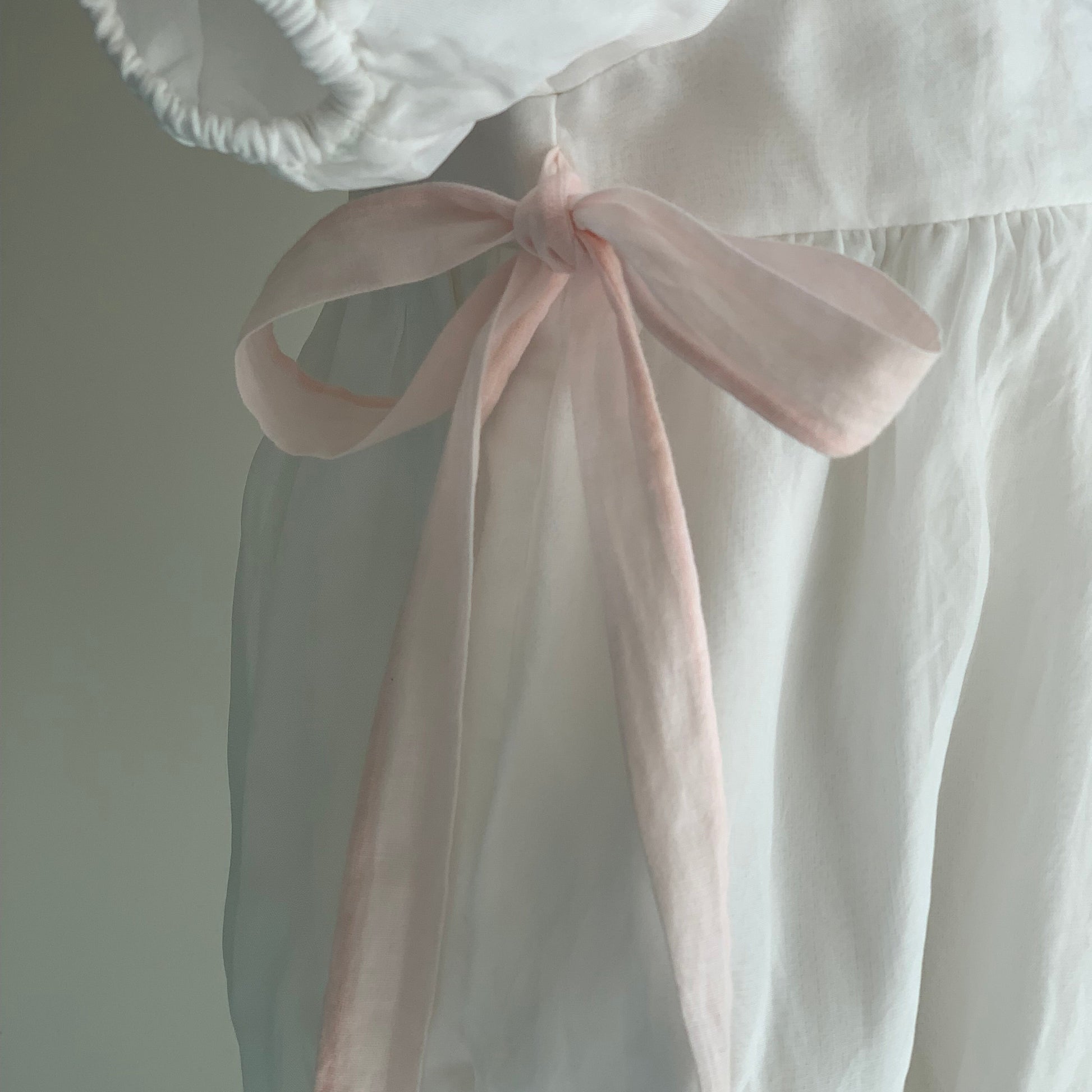 Rose Romper on mannequin close up, , baby girl romper, puff sleeve, bow detail.  — Willowby, sizes 6–18 months