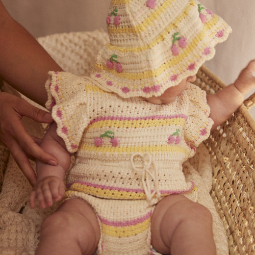 Paloma Romper on model, bohemian beach style crochet baby girl romper — Bebe Organic, sizes 6–18 months — Willowby
